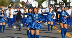 women parading in blue cheerleading outfits 
