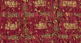 red fringe textile with yellow designs