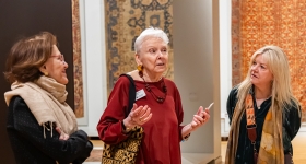 two woman listen to a tour guide 