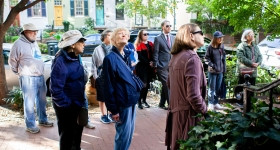 a group of people on a walking tour of a nieghborhood
