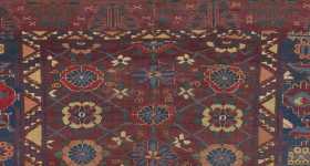 Carpet with dark red ground and small floral medallion motifs
