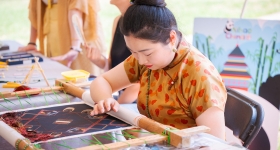 a young woman working on a textile project